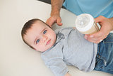 Innocent baby with father feeding milk