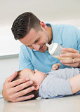 Father feeding milk to baby