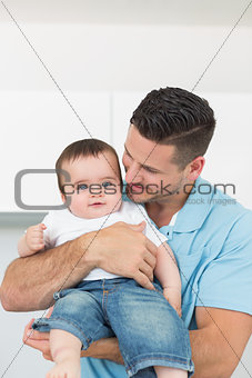 Loving father carrying baby