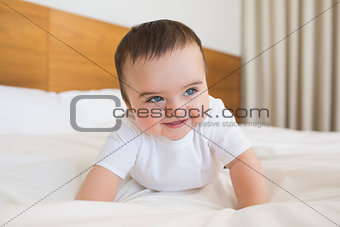 Happy baby boy in bed