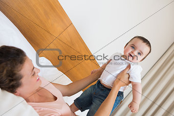 Mother playing with cute baby