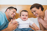 Cheerful baby with parents
