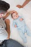 Loving father with baby on bed