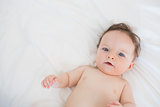 Portrait of lovely baby lying in bed