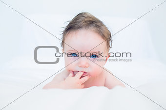 Cute baby with finger in mouth