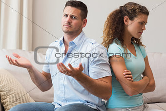 Man gesturing while arguing with woman
