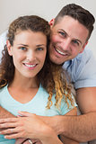 Affectionate man embracing woman  at home