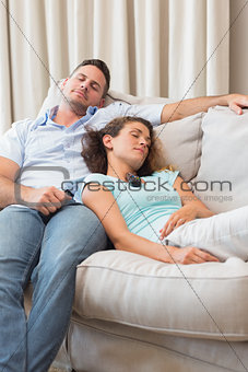 Couple sleeping on sofa