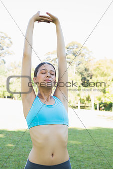 Woman stretching hands at park