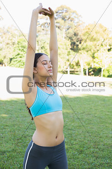 Fit woman exercising in park