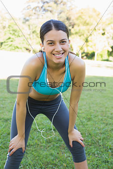 Sporty woman listening music in park