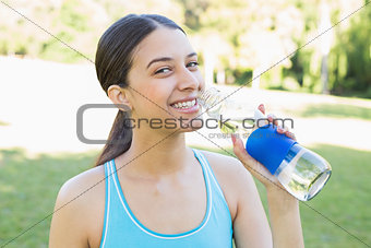 Portrait of sporty woman drinking water