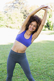 Smiling woman exercising in park