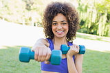 Woman lifting free weights in park