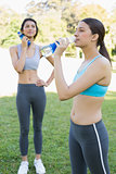 Sporty women drinking water