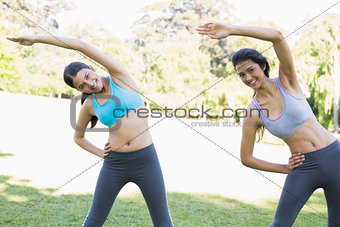 Women stretching in park