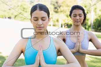 Women meditating in park