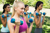 Dedicated women lifting free weights