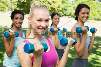Multiethnic sporty women weightlifting