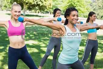 Sporty women lifting hands weights