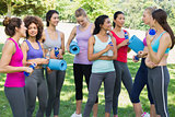 Multiethnic sporty women talking in park