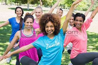Women performing fitness dance in park