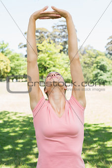 Woman performing stretching exercise at park