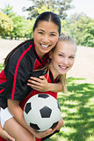 Female soccer player piggybacking teammate