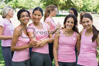Female volunteers participating in breast cancer awareness