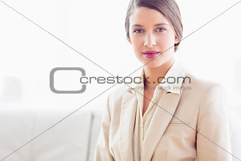 Young businesswoman sitting on sofa looking at camera