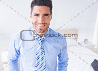 Handsome businessman smiling at camera