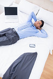 Sleeping handsome businessman lying on his bed