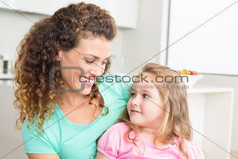 Happy mother and daughter looking at each other