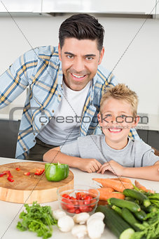 Smiling father showing his son how to prepare vegetables