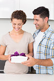 Cheerful woman holding a gift from her partner
