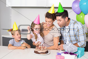 Happy young family celebrating a birthday together