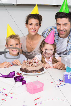 Smiling young family celebrating a birthday together