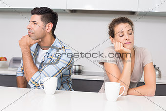 Unhappy couple having coffee not talking