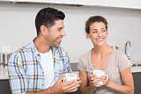 Attractive couple sitting having coffee together