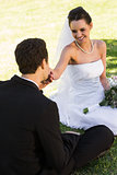 Groom kissing his beautiful bride's hand at park