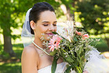 Close-up of a beautiful bride with bouquet in park