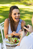 Man proposing cheerful woman at an outdoor café