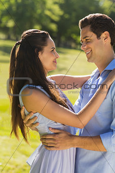 Loving young couple embracing at park
