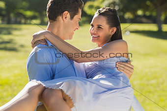 Man carrying woman in park