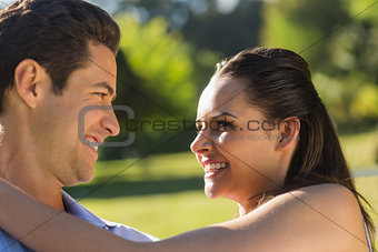 Loving and happy couple looking at each other at park