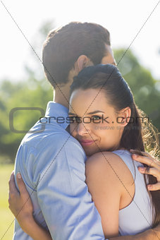 Side view of young couple embracing at park