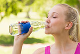 Close-up of a woman drinking water in park