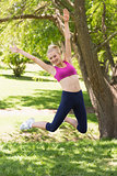 Full length of woman in sportswear jumping at park