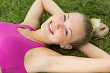 Relaxed beautiful woman lying on grass in park