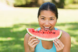 Portrait of a woman eating watermelon in park